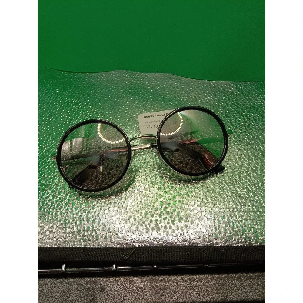 Ophelia Roe sunglasses with a black round frame and silver-tone metal temples